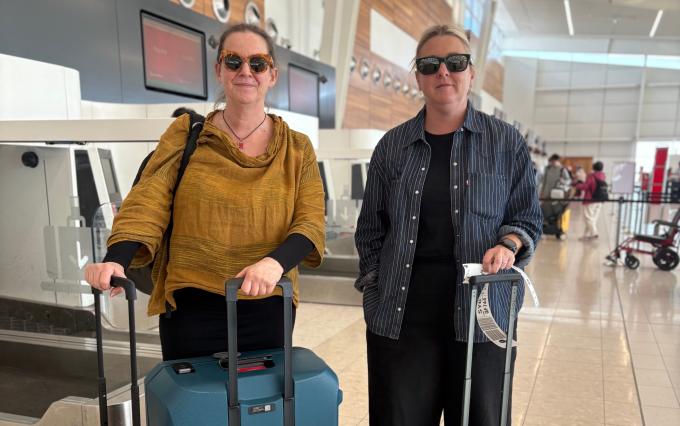 Professor Rebecca McKetin standing alongside her colleague Lucy at the airport